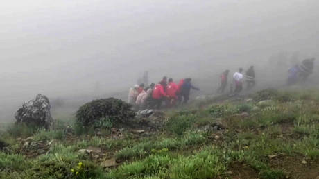 Rescuers recovering bodies at the site of President Ebrahim Raisi's helicopter crash.