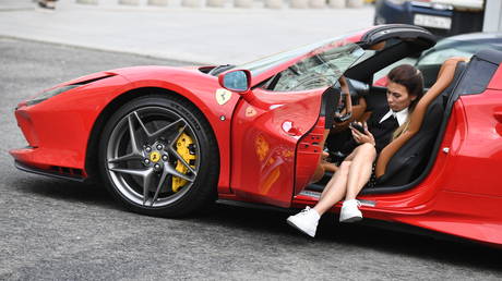 FILE PHOTO: The girl at the Italian supercar Ferrari F8 Tributo on the street of Moscow.