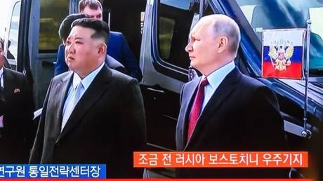 A TV screenshot shows Russian President Vladimir Putin and North Korean leader Kim Jong-un meeting last September in Russia's Amur Region.