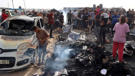Palestinians gather at the site of an Israeli strike on a camp for internally displaced people in Rafah.