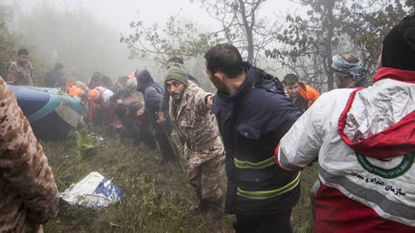Rescue team members work at the crash site of a helicopter carrying Iranian President Ebrahim Raisi in Varzaghan, in northwestern Iran, on May 20, 2024.