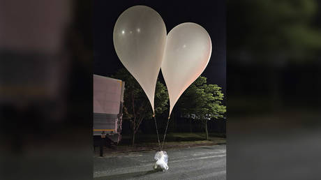 This handout photo taken by the South Korean Defence Ministry between May 28 and 29, 2024 shows unidentified objects believed to be North Korean balloons on a street in Chungnam Province.