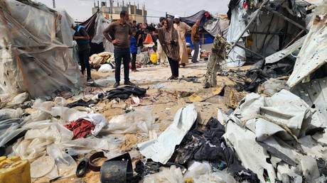 Palestinians examine the destroyed makeshift tents after Israeli army attacks in Rafah, Gaza on May 28, 2024.