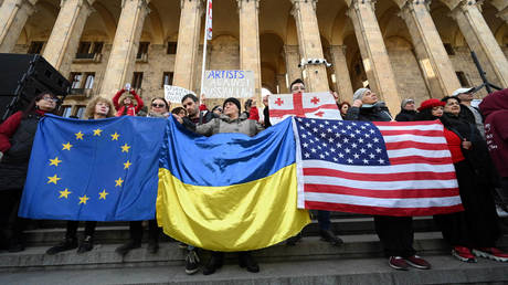 File photo: Protesters outside Georgian Parliament hold EU, Ukrainian, and US flags, Tbilisi, March 8, 2023.