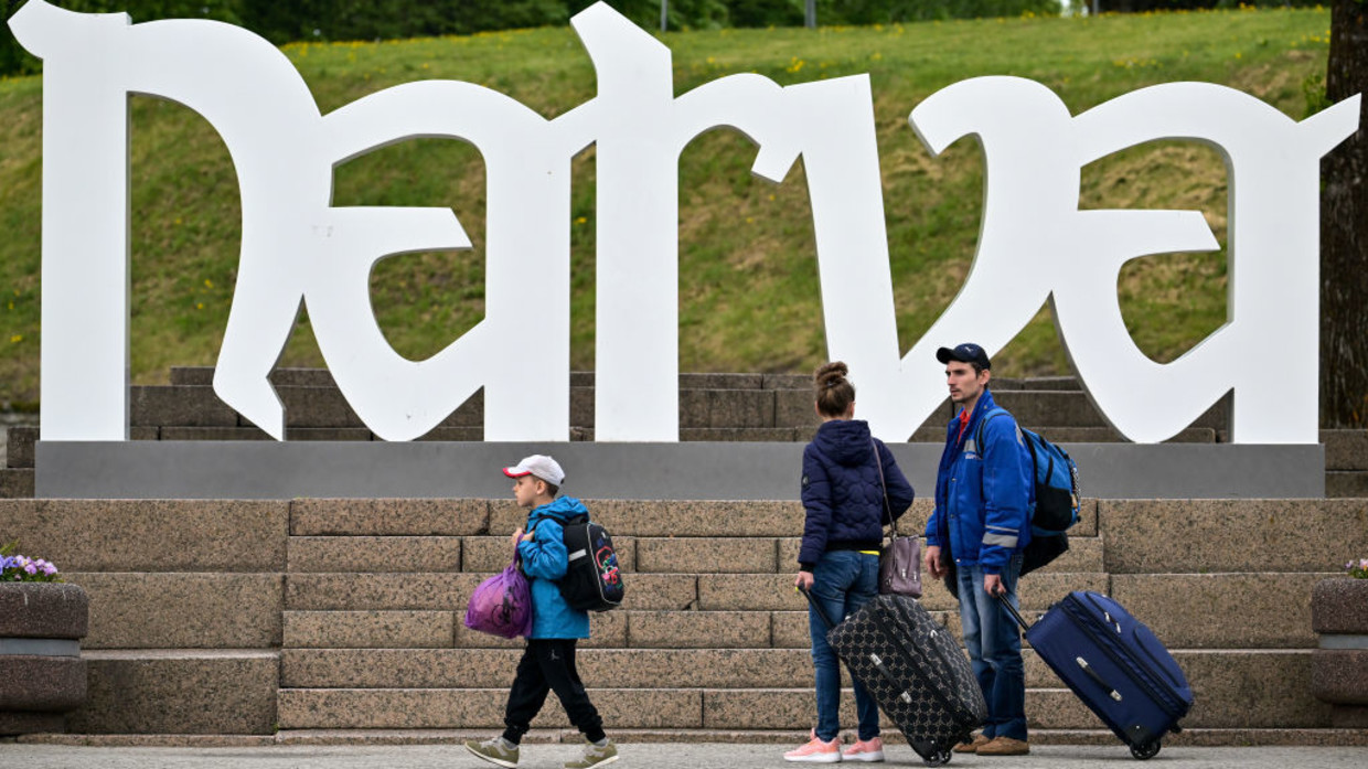 People walk past the Narva sign next to the border crossing from Estonia into Russia on May 27, 2022 in Narva, Estonia.