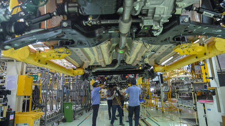 A worker assembles a car at a FCA India Automobiles manufacturing facility in Ranjangaon, some 200km east of Mumbai, on July 23, 2019.