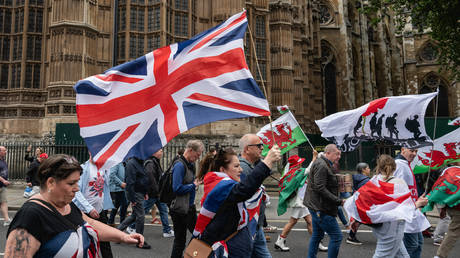 Tommy Robinson's supporters march into Parliament square on June 1, 2024 in London, England.