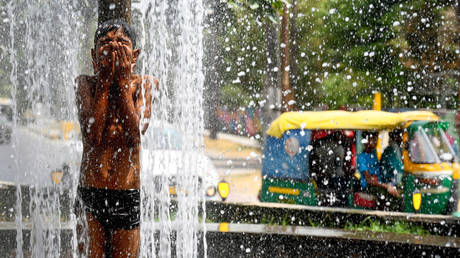 Child cools down in water fountain in scorching heat at sector 34 on May 29, 2024 in Noida, India. Maximum temperature reaching as high as 47.3C, highest recorded this season.