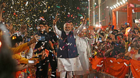 India’s Prime Minister Narendra Modi flashes victory sign as he arrives at the Bharatiya Janata Party (BJP) headquarters to celebrate the results of India's general election, in New Delhi on June 4, 2024