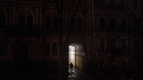 FILE PHOTO: A woman walks through a passage in Kiev during a blackout, after Russian strikes targeted Ukraine's power infrastructure, December 16, 2022.