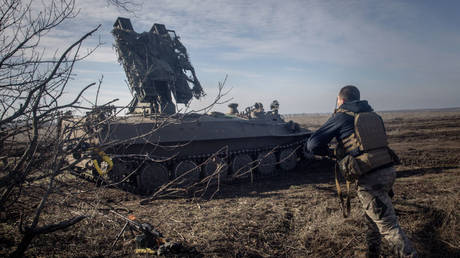FILE PHOTO: A member of Ukraine's 72nd Brigade Anti-air unit runs to a position as they prepare to fire a Strela -10 anti-air missile system on February 23, 2024 near Marinka, Ukraine.