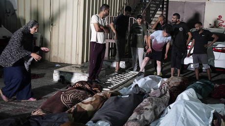Palestinians mourn relatives killed in an Israeli bombardment of a UNRWA-run school at the Nusseirat refugee camp, central Gaza, June 6, 2024
