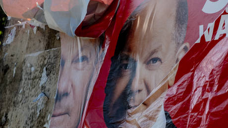 A damaged election poster shows German Chancellor Olaf Scholz in Frankfurt, Germany, June 9, 2024