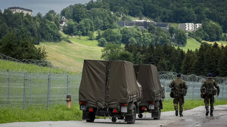 Swiss soldiers walk outside the luxury Burgenstock resort in central Switzerland.