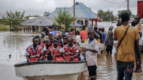 FILE PHOTO. Members of the International Federation of Red Cross and Red Crescent Societies (IFRC) gather on a boat as residents are rescued in an area heavily affected by floods following torrential rains in the Rufiji District village of Mohoro, on April 17, 2024.
