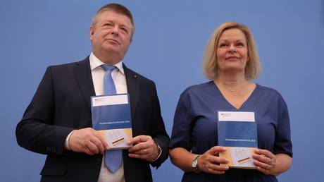 Germany’s head of the Office for the Protection of the Constitution Thomas Haldenwang (L) and Interior Minister Nancy Faeser present the 2023 report on the agency’s activities on June 18, 2024.