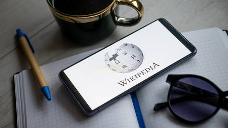 A Wikipedia logo seen displayed on a smartphone.