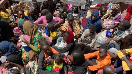 FILE PHOTO.  Refugees from Sudan sit crowded together in a boat that is supposed to take them from the southern Sudanese border town of Renk on the White Nile to Malakal for further accommodation.