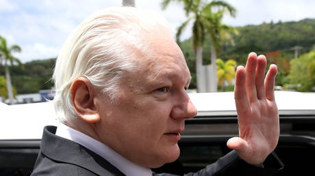 WikiLeaks founder Julian Assange waves as he leaves the United States Courthouse on June 26, 2024 in Saipan, Northern Mariana Islands.