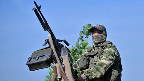 FILE PHOTO: A Russian serviceman of the Central military district prepares to fire a machine gun at an air target amid Russia's military operation in Ukraine, at an unknown location, in Russia.