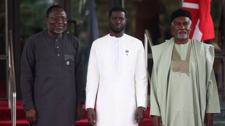 President of Economic Community of West African States Commission (ECOWAS), Omar Touray (L), Senegal President, Bassirou Diomaye Faye (C), and Nigeria Minister of Foreign Affairs Yussuf Tuggar (R) in Abuja on July 7, 2024.