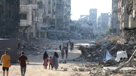 Palestinians leaving a bombed-out Gaza City neighborhood after the IDF's evacuation orders on July 09, 2024