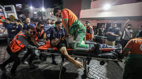 FILE PHOTO: A Palestinian civil defence officer injured in Israeli attacks is given CPR on a stretcher at Al-Shifa Hospital in Gaza Strip, Gaza on October 16, 2023.
