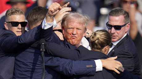 Republican presidential candidate former President Donald Trump pumps his fist as he is helped off the stage at a campaign event in Butler, Pa., on Saturday, July 13, 2024.