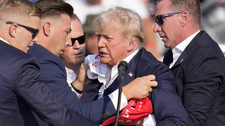 Republican presidential candidate former President Donald Trump is helped off the stage at a campaign event in Butler, Pa., on Saturday, July 13, 2024.