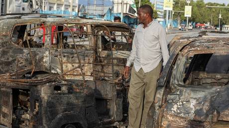 A man looks at the debris and destruction at a cafe in Mogadishu on July 15, 2024 following a car bomb blast.