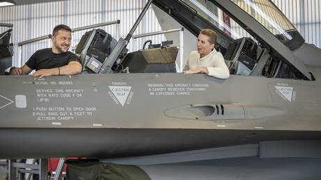 Ukrainian leader Vladimir Zelensky (L) and Danish Prime Minister Mette Frederiksen in an F-16 fighter jet at Skrydstrup Airbase in Vojens, Denmark, August 20, 2023.