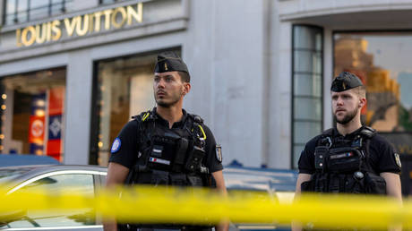 Police stand guard near Louis Vuitton store after a stabbing incident in the Champs Elysees shopping district on July 18, 2024 in Paris, France.