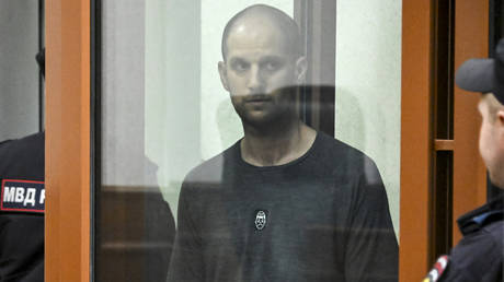 US journalist Evan Gershkovich, accused of espionage, stands inside a glass defendants' cage during the verdict announcement at the Sverdlovsk Regional Court in Yekaterinburg on July 19, 2024.