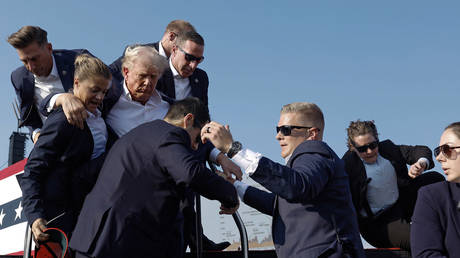 Donald Trump is rushed away by Secret Service agents after an assassination attempt at a rally in Pennsylvania, July 13, 2024.