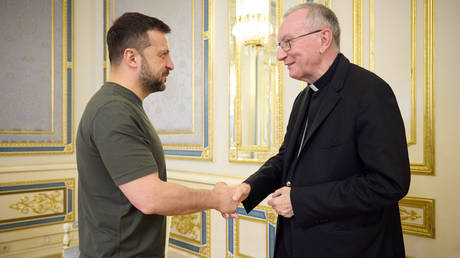 Vladimir Zelensky (L) greets Vatican's Secretary of State Pietro Parolin in Kiev