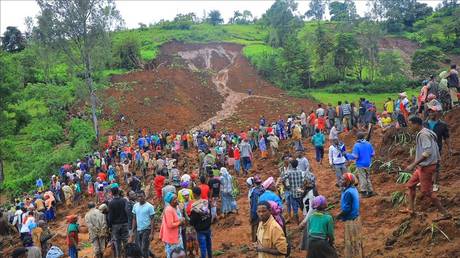 In this grab made from a handout footage released by the Gofa Zone Government Communication Affairs Department on July 22, 2024, shows people standing at the bottom of a landslide that occurred in the Geze-Gofa district.