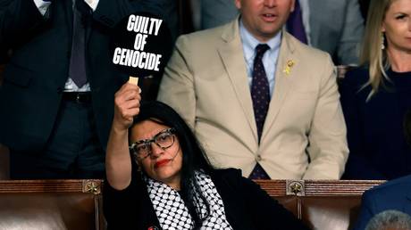 Rashida Tlaib holds a protest sign as Israeli Prime Minister Benjamin Netanyahu addresses a joint meeting of Congress on Capitol Hill in Washington DC, July 24, 2024
