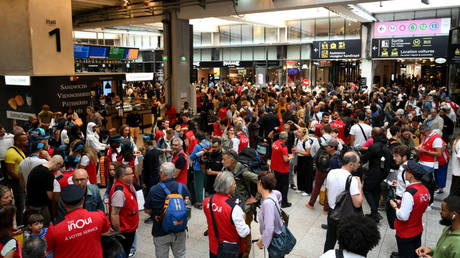 Passengers gather at Montparnasse train station after damage to high-speed rail lines caused delays and cancellations, Paris, France, July 26, 2024.