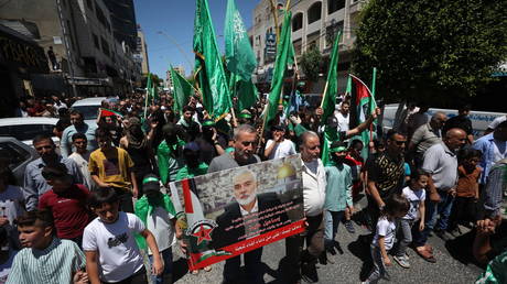 FILE PHOTO: Palestinians denounce the killing of Hamas political leader Ismail Haniyeh in the occupied West Bank city of Hebron on July 31, 2024.