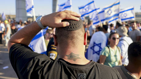 Israelis demonstrate outside the Sde Teman military base near Beersheba against the detention of military reservists suspected of abusing a Palestinian detainee, July 29, 2024.