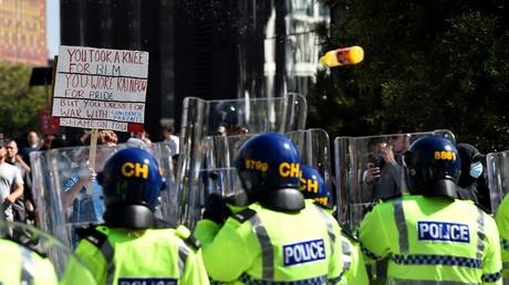 A bottle is thrown towards police officers in Liverpool, England, August 3, 2024