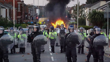 Riot police hold back protesters after disorder broke out on July 30, 2024 in Southport, England.