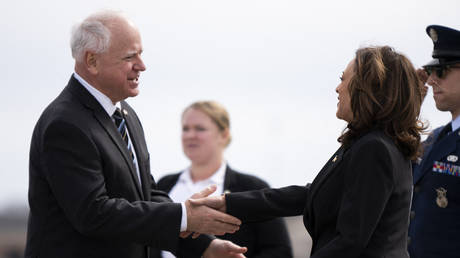 FILE PHOTO: Minnesota Governor Tim Walz (L) greets US Vice President Kamala Harris at the Minneapolis-St. Paul International Airport, March 14, 2024.