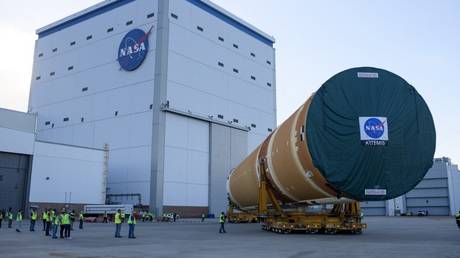 NASA employees watch as the Artemis II rocket core stage is wheeled out at the Michoud Assembly Facility in New Orleans, Louisiana, July 16, 2024