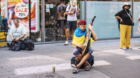 A Ukrainian refugee plays a bandura in Cologne, Germany, July 20, 2022.