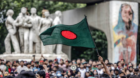 A student waves Bangladesh's national flag, during a protest to demand accountability and trial against the country's ousted Prime Minister Sheikh Hasina, near Dhaka University in the capital on August 12, 2024.