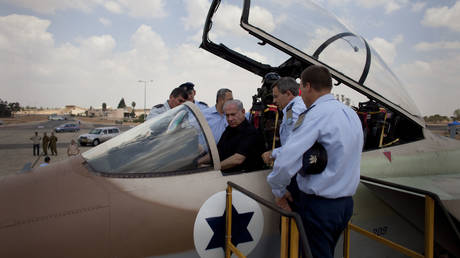 FILE PHOTO: Israeli Prime Minister Benjamin Netanyahu in the cockpit of an F-15i fighter jet