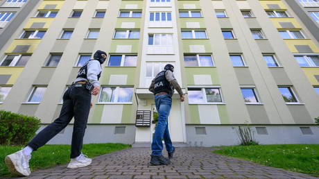 FILE PHOTO: Officers from Germany's Federal Criminal Police Office (BKA) enter an apartment building for a search