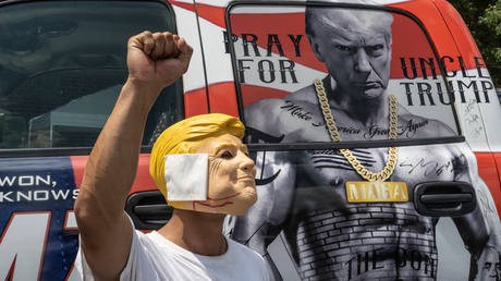 A person in a Trump mask ahead of a rally in Harrisburg, Pennsylvania, July 31, 2024