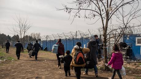 FILE PHOTO: A Syrian family on the Serbian side of the border with Hungary.